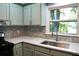 Kitchen featuring a stainless steel sink and stylish backsplash under a window at 5452 E Lakeland Dr, North Charleston, SC 29406