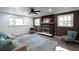 Comfortable living room featuring a fireplace, hardwood floors, and plenty of natural light at 5452 E Lakeland Dr, North Charleston, SC 29406