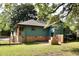 Charming home featuring a patio with a brick grill and steps leading to a wooden porch at 5452 E Lakeland Dr, North Charleston, SC 29406