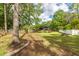 Lush backyard with a serene pond view, mature trees, and manicured lawn at 5496 Clearview Dr, North Charleston, SC 29420