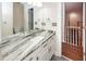Bright bathroom featuring a marble countertop, white cabinets, and modern fixtures at 5496 Clearview Dr, North Charleston, SC 29420