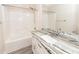 Bright bathroom with granite topped single sink vanity and a shower-tub combination at 5496 Clearview Dr, North Charleston, SC 29420