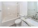 A clean bathroom with a single granite vanity and a white tiled shower-tub combination at 5496 Clearview Dr, North Charleston, SC 29420