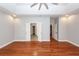 Spacious main bedroom with hardwood floors, tray ceilings, neutral paint, and a set of doors leading to additional rooms at 5496 Clearview Dr, North Charleston, SC 29420