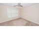Simple carpeted bedroom with a ceiling fan and a window with blinds at 5496 Clearview Dr, North Charleston, SC 29420