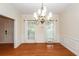Well-lit dining room featuring decorative moldings, wood floors, and a stylish chandelier at 5496 Clearview Dr, North Charleston, SC 29420