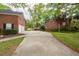 The house's driveway view showcases a concrete driveway and brick home at 5496 Clearview Dr, North Charleston, SC 29420