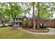 Charming home features a double porch, brick facade, and mature landscaping at 5496 Clearview Dr, North Charleston, SC 29420