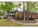 Charming home features a double porch, brick facade, and mature landscaping at 5496 Clearview Dr, North Charleston, SC 29420