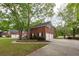 Spacious home with a manicured lawn, brick exterior, and a three-car garage at 5496 Clearview Dr, North Charleston, SC 29420