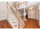 Grand foyer with hardwood floors, staircase with white railings, and formal living space at 5496 Clearview Dr, North Charleston, SC 29420