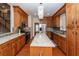 Well-lit kitchen with granite countertops, wood cabinets, stainless appliances, and an island with a butcher block countertop at 5496 Clearview Dr, North Charleston, SC 29420