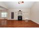 Cozy living room featuring a fireplace, hardwood floors, and large windows at 5496 Clearview Dr, North Charleston, SC 29420