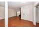 Hardwood floors in a light-filled living room with front entry and view to formal dining room at 5496 Clearview Dr, North Charleston, SC 29420