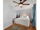 Bedroom with light grey walls, hardwood floors, and blue curtains at 5703 St Angela Dr, North Charleston, SC 29418