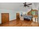 Upstairs bedroom with wooden floors, ceiling fans and view of the lake outside at 5703 St Angela Dr, North Charleston, SC 29418