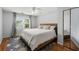 Bright bedroom with light grey walls, hardwood floors, and a window to outside at 5703 St Angela Dr, North Charleston, SC 29418