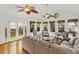 Bright sun room with many windows, French doors, ceiling fans, and comfortable seating area at 5703 St Angela Dr, North Charleston, SC 29418