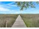 Picturesque walkway through a marsh leading to a peaceful gazebo at 5703 St Angela Dr, North Charleston, SC 29418