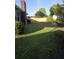 Large, shady backyard featuring a freshly installed wood fence and lush green grass at 5937 Willard Dr, Hanahan, SC 29410