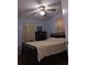 A cozy bedroom featuring a ceiling fan, dark wood furnishings, and neutral colored curtains at 5937 Willard Dr, Hanahan, SC 29410