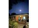 Charming brick home with front porch, rocking chairs, and landscaped yard under the moon light at 5937 Willard Dr, Hanahan, SC 29410