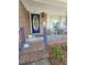 Inviting front porch with blue railing, brick steps, and a charming blue front door at 5937 Willard Dr, Hanahan, SC 29410