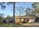 Charming single-story brick home featuring a well-manicured lawn and attached garage at 5937 Willard Dr, Hanahan, SC 29410