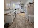 Bright kitchen featuring white cabinets, stainless steel appliances, and modern flooring at 5937 Willard Dr, Hanahan, SC 29410