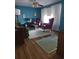 Bright living room with hardwood floors, blue walls, and traditional furnishings at 5937 Willard Dr, Hanahan, SC 29410
