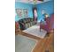 Bright living room features hardwood floors, blue walls, and elegant, traditional furnishings at 5937 Willard Dr, Hanahan, SC 29410