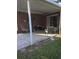 Covered outdoor patio featuring brick flooring, seating, and views of the backyard at 5937 Willard Dr, Hanahan, SC 29410