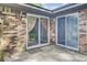 Back patio with brick siding, sliding glass doors, and outdoor access at 621 Temple Rd # A, Ladson, SC 29456