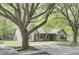 Traditional-style home with mature trees, a brick accent wall, and a paved driveway for convenient parking at 621 Temple Rd # A, Ladson, SC 29456