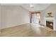 Bright living room featuring vaulted ceiling, hardwood floors, fireplace and sliding doors to the backyard at 621 Temple Rd # A, Ladson, SC 29456