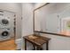 Rustic half-bath features a wood vanity, copper fixtures, patterned sink, and adjacent washer and dryer at 642 Harbor Creek Pl # 21, Charleston, SC 29412