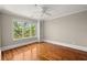 Bedroom featuring hardwood floors, built in shelves, and large windows overlooking greenery at 642 Harbor Creek Pl # 21, Charleston, SC 29412