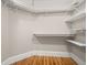 Walk-in closet with white shelving and hardwood floors at 642 Harbor Creek Pl # 21, Charleston, SC 29412