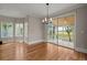 Dining room with hardwood floors, chandelier, and sliding glass doors to the outside at 642 Harbor Creek Pl # 21, Charleston, SC 29412
