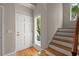 Bright entryway with hardwood floors, white trim, and staircase, creating a welcoming ambiance at 642 Harbor Creek Pl # 21, Charleston, SC 29412