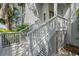 Inviting front porch with painted stairs, railings, and latticework, leading to the front door at 642 Harbor Creek Pl # 21, Charleston, SC 29412