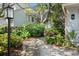 Pathway leading to the front entrance, adorned with lush landscaping and mature trees at 642 Harbor Creek Pl # 21, Charleston, SC 29412