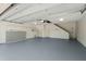 Spacious two car garage with clean floors, shelving, and bright lighting at 642 Harbor Creek Pl # 21, Charleston, SC 29412