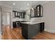 Well-lit kitchen with dark cabinets, stainless steel appliances, and a breakfast bar at 642 Harbor Creek Pl # 21, Charleston, SC 29412