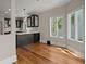 Open kitchen with hardwood floors, black cabinets, white countertops, and natural light from windows at 642 Harbor Creek Pl # 21, Charleston, SC 29412