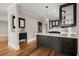 Kitchen featuring hardwood floors, stainless steel appliances, black cabinets and an island at 642 Harbor Creek Pl # 21, Charleston, SC 29412