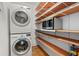 Laundry room features stacked washer and dryer, shelving, and a built-in microwave at 642 Harbor Creek Pl # 21, Charleston, SC 29412