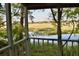 Serene porch view of a marsh, complete with lush greenery, and a glimpse of open sky at 642 Harbor Creek Pl # 21, Charleston, SC 29412