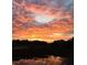Vibrant sunset of fiery orange and red skies over a serene marsh, with reflections in the water at 642 Harbor Creek Pl # 21, Charleston, SC 29412