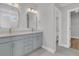 Bathroom with double vanity, framed mirrors, and neutral color scheme, showing the adjoining rooms at 701 Maynard Ln, Summerville, SC 29486